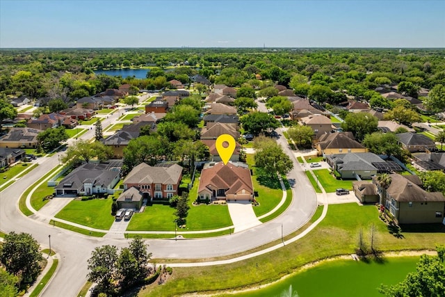 bird's eye view featuring a residential view, a view of trees, and a water view