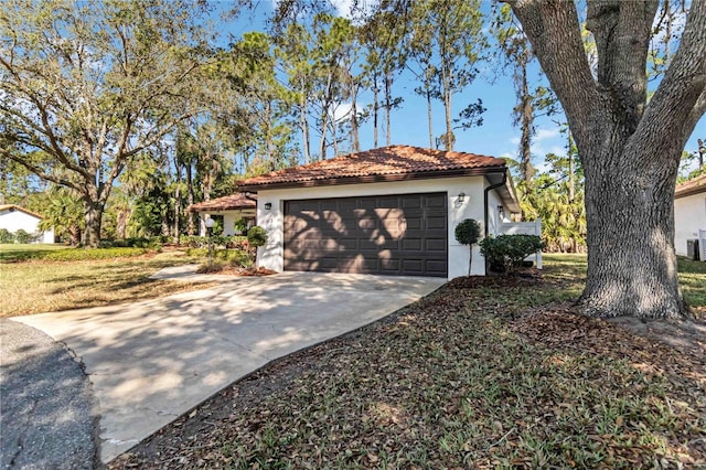 garage featuring concrete driveway