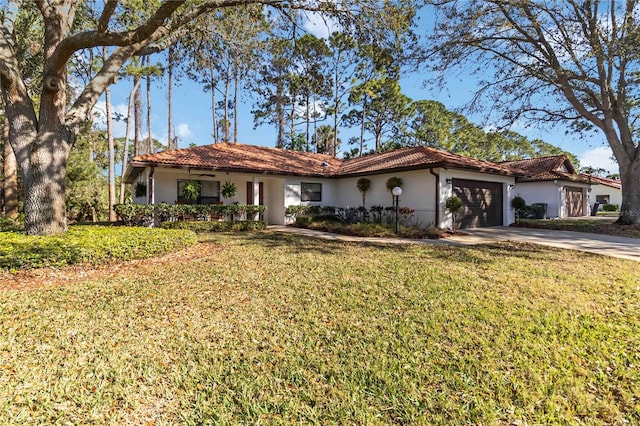 mediterranean / spanish-style house featuring stucco siding, a front lawn, driveway, a garage, and a tiled roof