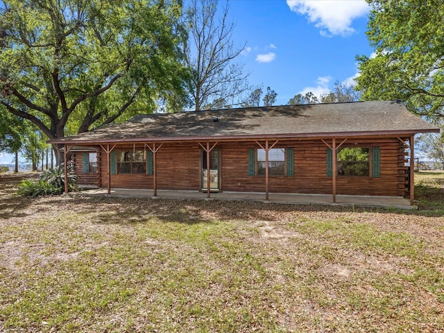 16510 Quarter Horse Ct, Montverde, FL 34756 - rear view of property with a lawn, log exterior, and a shingled roof