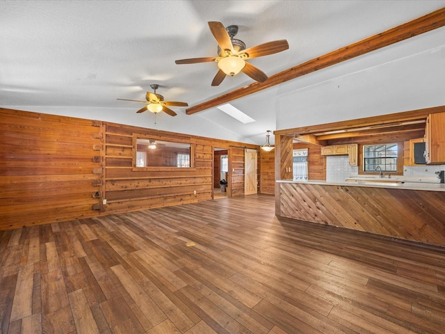 16510 Quarter Horse Ct, Montverde, FL 34756 - unfurnished living room with a ceiling fan, dark wood-style flooring, wood walls, and a sink