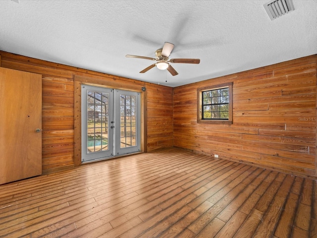 16510 Quarter Horse Ct, Montverde, FL 34756 - unfurnished room with visible vents, a ceiling fan, hardwood / wood-style flooring, a textured ceiling, and french doors