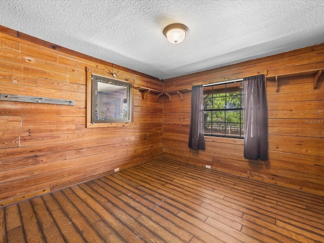 16510 Quarter Horse Ct, Montverde, FL 34756 - spare room featuring a textured ceiling, wooden walls, wood finished floors, and a sauna