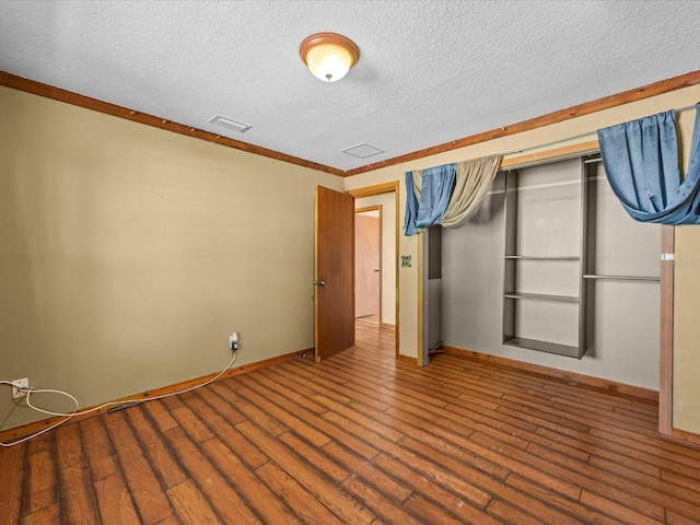 16510 Quarter Horse Ct, Montverde, FL 34756 - unfurnished bedroom with visible vents, wood finished floors, baseboards, and a textured ceiling