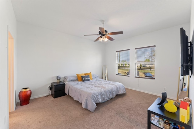 carpeted bedroom with baseboards and ceiling fan