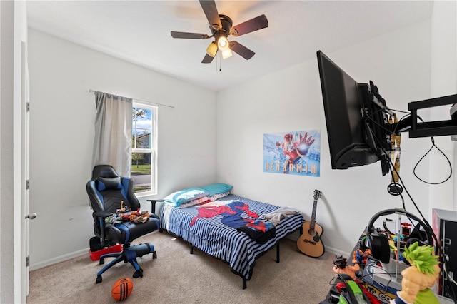 carpeted bedroom with a ceiling fan and baseboards