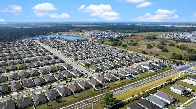 birds eye view of property featuring a water view and a residential view