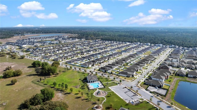 drone / aerial view with a residential view and a water view