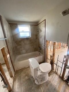 full bath featuring shower / bathing tub combination and toilet