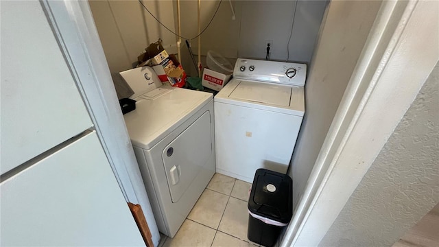 laundry room with light tile patterned floors, laundry area, and washer and dryer