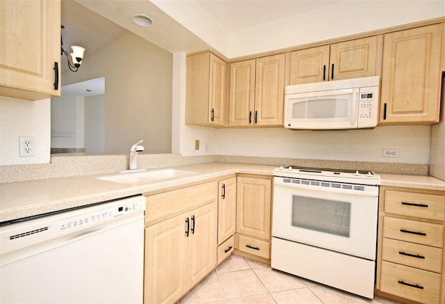 kitchen featuring a sink, white appliances, light brown cabinets, and light tile patterned floors