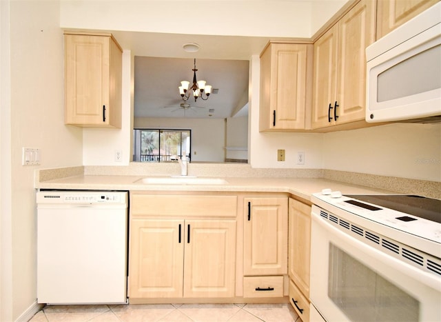 kitchen featuring light brown cabinetry, white appliances, an inviting chandelier, and a sink