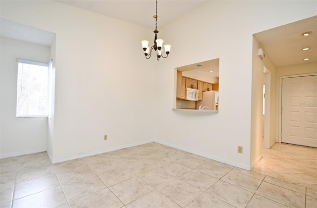 spare room with light tile patterned floors, a notable chandelier, and baseboards