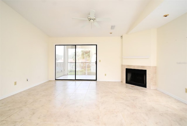 unfurnished living room with a fireplace, light tile patterned floors, a ceiling fan, and baseboards