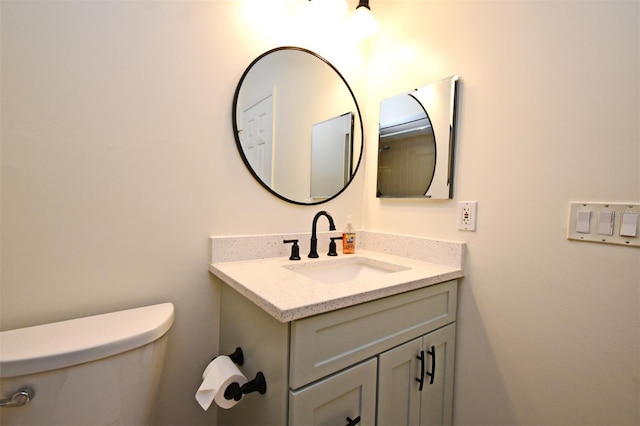 bathroom with toilet and vanity