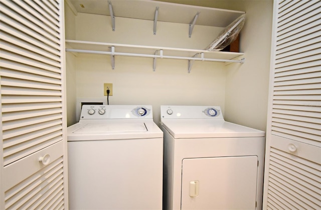 clothes washing area with laundry area and washer and dryer