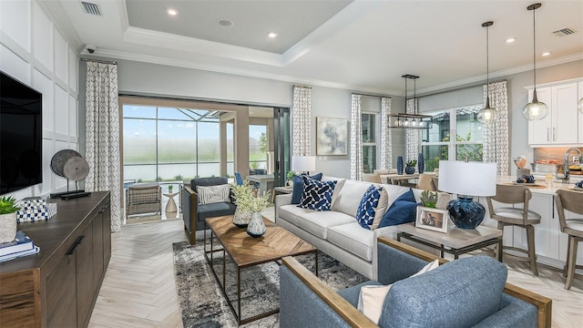 living area featuring crown molding, recessed lighting, visible vents, and a raised ceiling