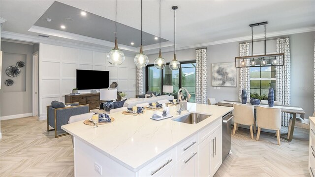 kitchen with a sink, white cabinets, dishwasher, crown molding, and a raised ceiling