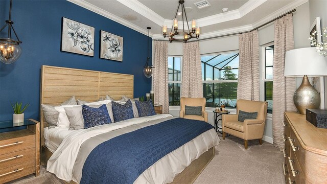 carpeted bedroom featuring visible vents, crown molding, a tray ceiling, and an inviting chandelier