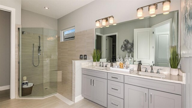 full bathroom featuring double vanity, vaulted ceiling, a walk in shower, and a sink