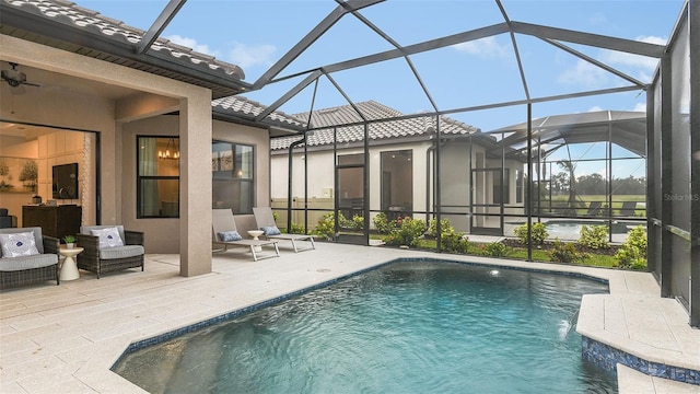 outdoor pool with glass enclosure and a patio