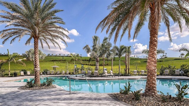 community pool featuring a patio and fence