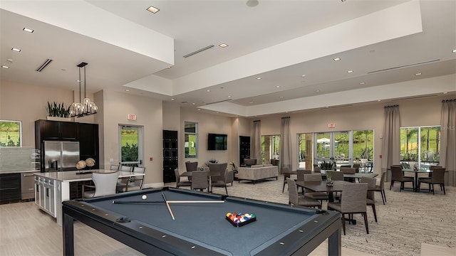 recreation room featuring recessed lighting, pool table, a raised ceiling, and a high ceiling