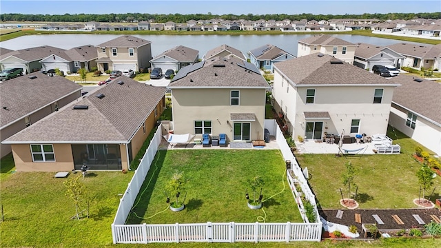 drone / aerial view with a water view and a residential view