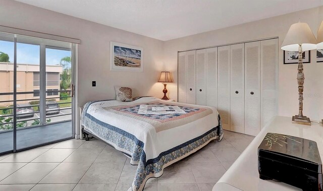 bedroom featuring light tile patterned flooring, a closet, and access to outside