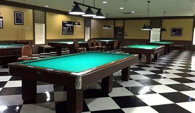 rec room with pool table, tile patterned floors, and wainscoting