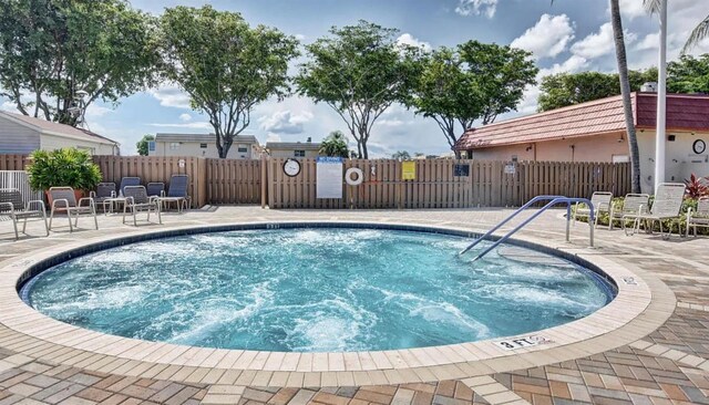 view of pool with a patio and fence