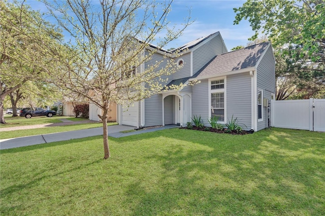 view of front of home featuring a front lawn, a gate, fence, and driveway