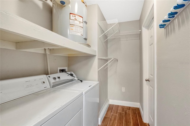 washroom featuring baseboards, wood tiled floor, independent washer and dryer, and laundry area