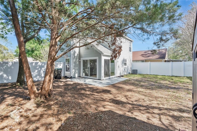 back of property with cooling unit, a patio, and a fenced backyard