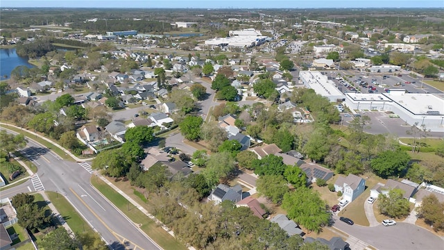 drone / aerial view featuring a residential view and a water view