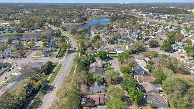 drone / aerial view featuring a residential view and a water view