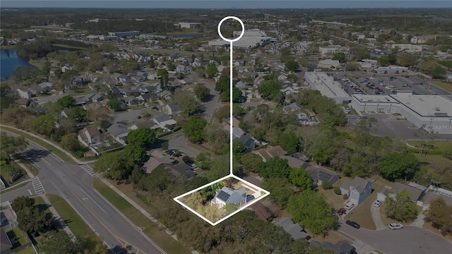 drone / aerial view with a residential view and a water view