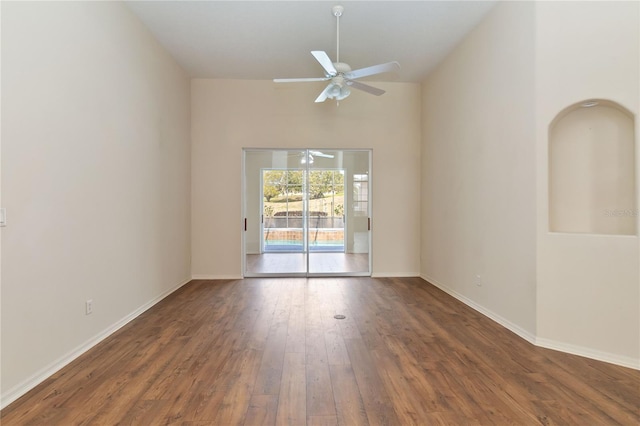 spare room with ceiling fan, baseboards, and hardwood / wood-style flooring