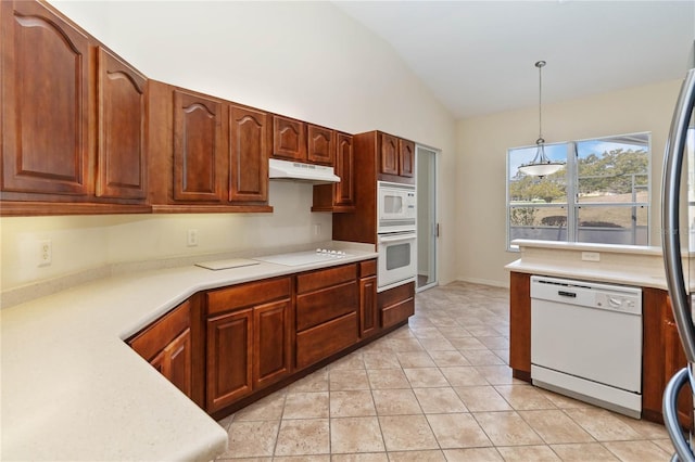 kitchen featuring under cabinet range hood, decorative light fixtures, white appliances, light countertops, and lofted ceiling