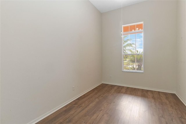 empty room with baseboards and hardwood / wood-style floors