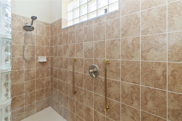 bathroom with tiled shower