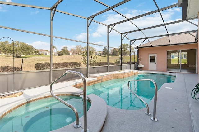 view of swimming pool featuring a pool with connected hot tub, a lanai, and a patio area