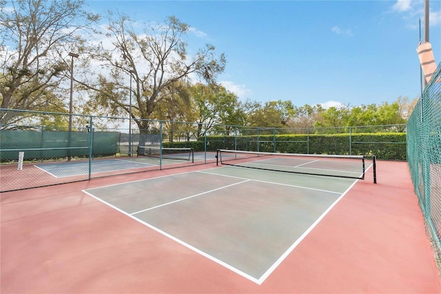 view of sport court with fence