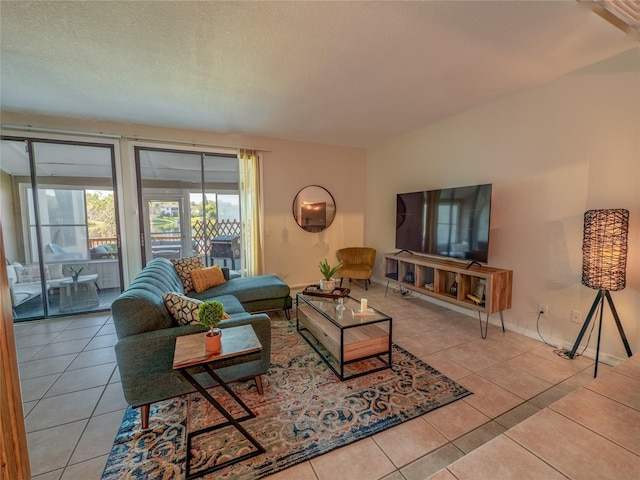 tiled living room with a textured ceiling and baseboards