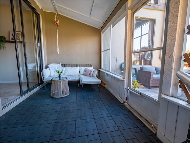 sunroom featuring vaulted ceiling