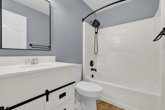 bathroom with wood finished floors, toilet, vanity, and washtub / shower combination