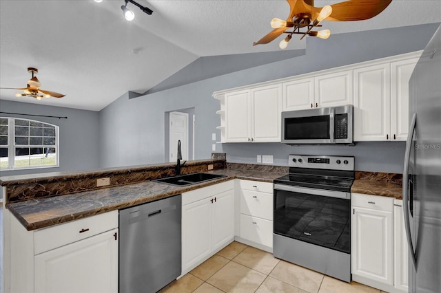 kitchen with a ceiling fan, a sink, appliances with stainless steel finishes, a peninsula, and white cabinets