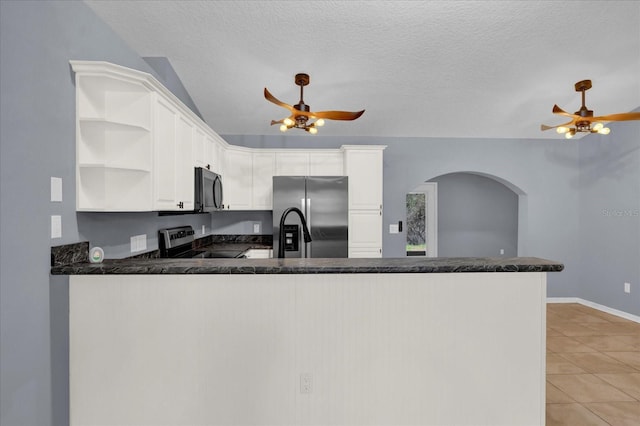 kitchen featuring ceiling fan, light tile patterned floors, a peninsula, stainless steel appliances, and open shelves