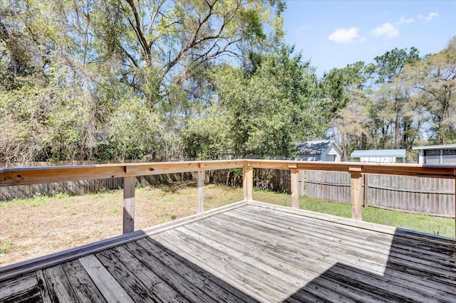 wooden terrace featuring fence