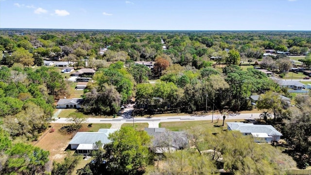 birds eye view of property with a view of trees